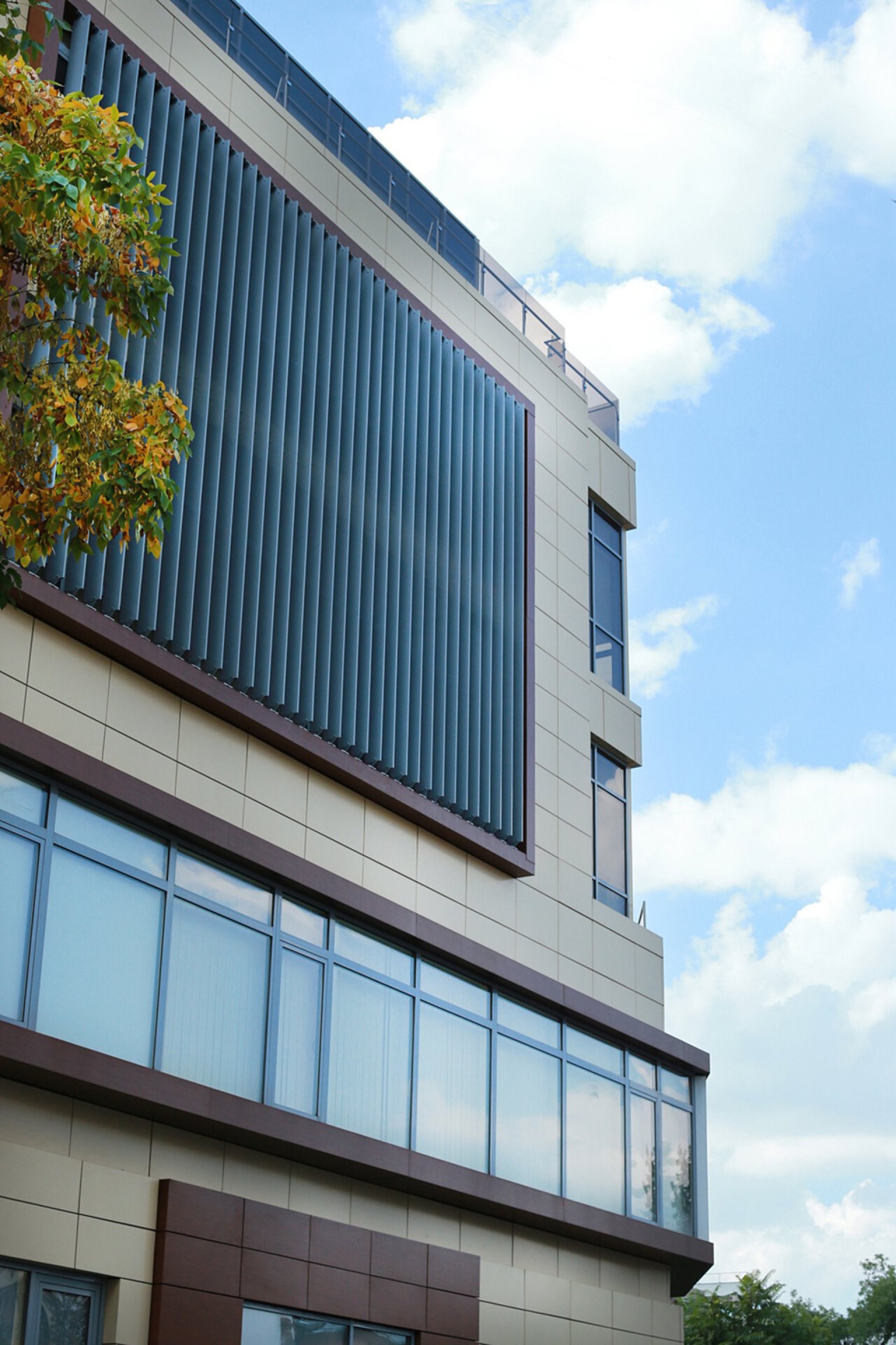 Facade detail of the Mihai Eminescu 100 building with vertical metal sunshades and ceramic facade panels, PPAE project for a private clinic building