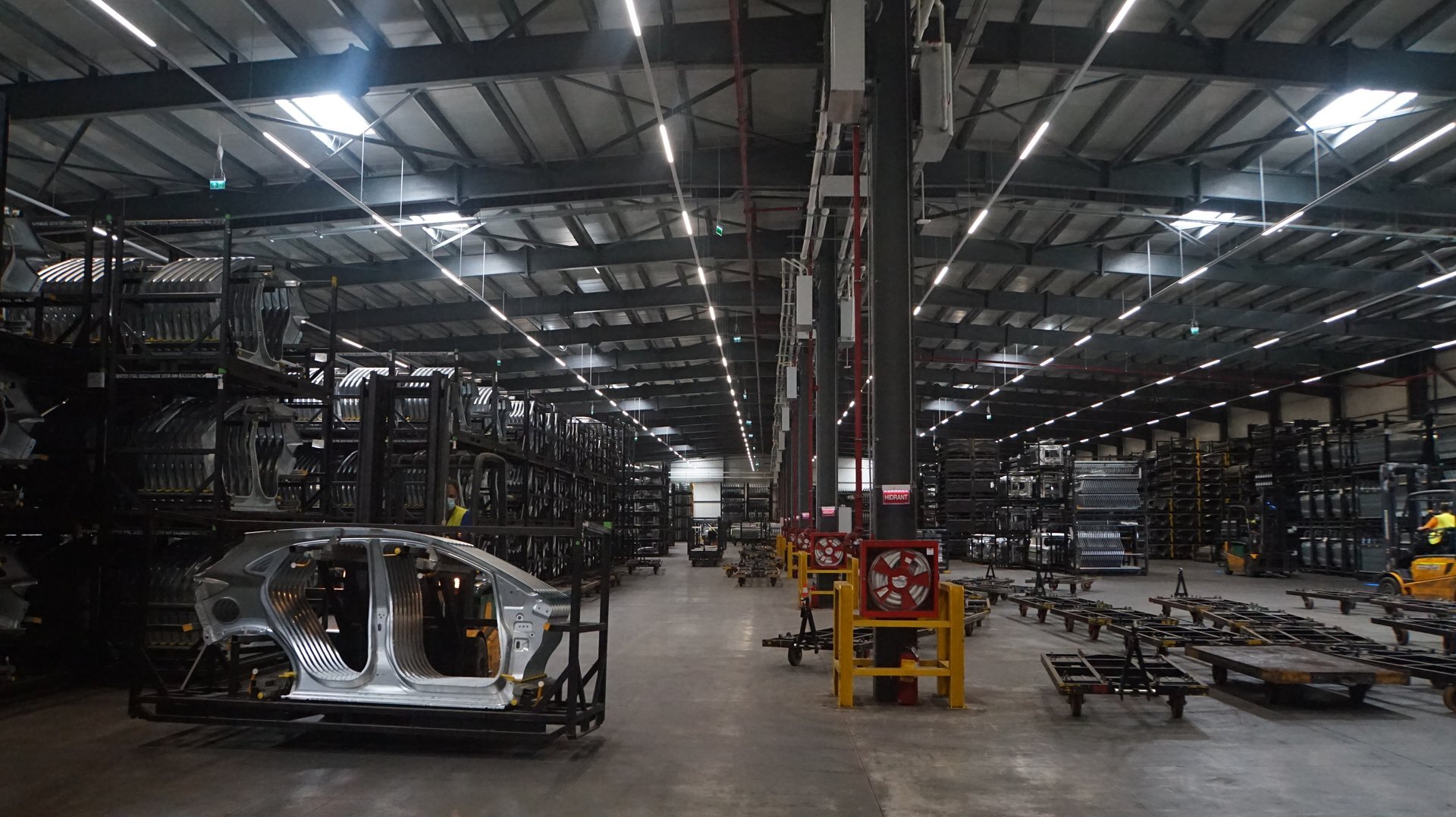 Interior of the Ford Craiova car-body storage hall with a steel structure and racks for automotive sub-assemblies, PPAE project